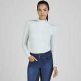 Rider wears the Pikeur Sports Mesh Long Sleeve Baselayer in Ice Blue with jeggings